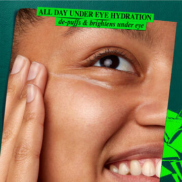 model adding eye cream to her under eye. all day under eye hydration de-puffs & brightens under eye 