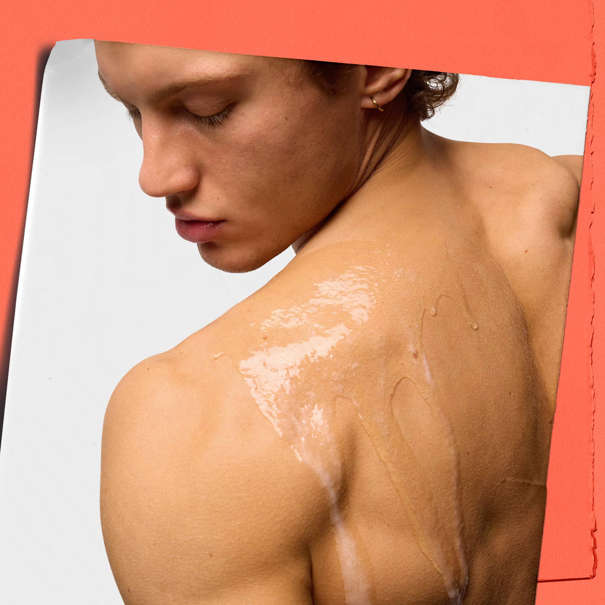 model with body cleanser on shoulder