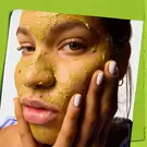 Model rubbing face mask into face 