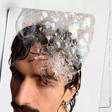 model with shampoo bubble in his hair 