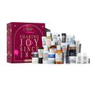 The Kiehl’s Advent Calendar displayed with the box on the left and 24 mini skincare and body care products arranged in front. The products include cleansers, toners, serums, masks, and moisturizers.​