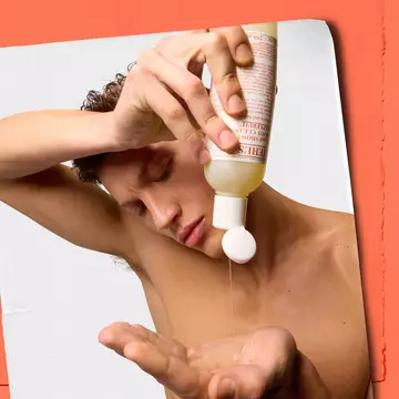 model squeezing out body cleanser into hand 