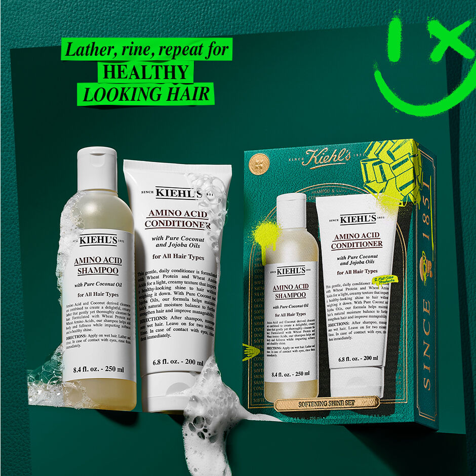 shampoo and conditioner next to set gift box with suds. lather, rinse, repeat for healthy looking hair 