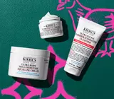 Ultra collection - body moisturizer, facial cream and face cleanser on green leather background