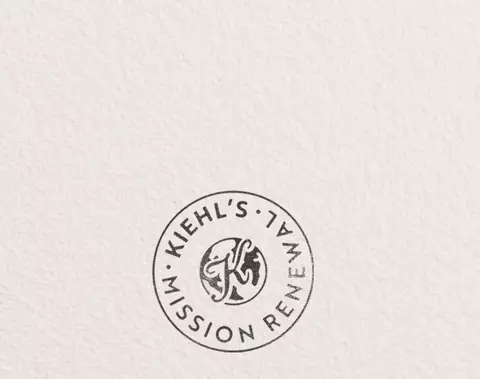 Kiehl’s Mission Renewal banner featuring a circular stamp logo and text reading, "Our imperfect journey to drive a more circular economy," promoting the brand's sustainability and circular economy initiative.