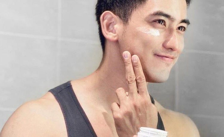 Man applying Kiehl's Ultra Facial Cream product to his face