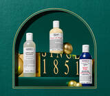 Body care items on green leather background 