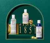 Body care items on green leather background