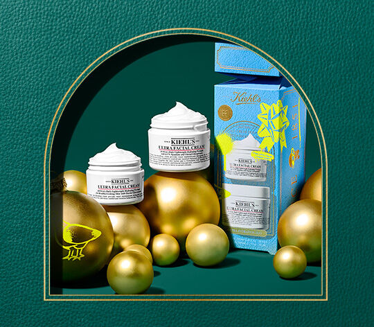 2 ultra facial creams on green leather background 