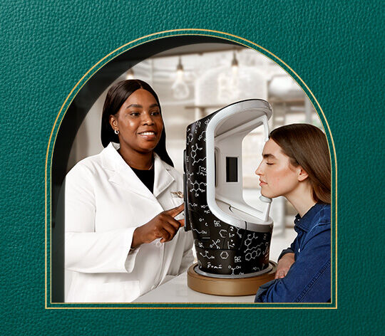 customer scanning face in store with Kiehl's Derma-Reader Skin Analysis