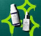 retinol and dark spot serums on green leather background