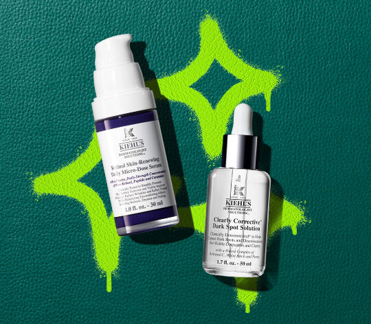 retinol and dark spot serums on green leather background 