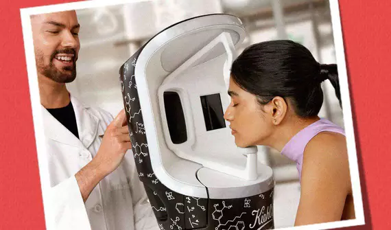 Kiehl’s skicare expert examining patient's skin with the Derma-Reader