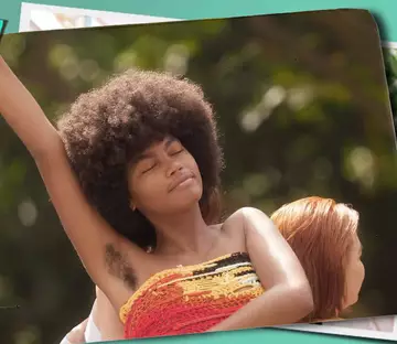 Model with arm raised and underarm hair