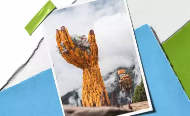 Large woven hand sculpture holding plastic waste against misty mountains, representing Kiehl’s cleanup and plastic renewal initiatives.​