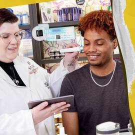 skincare expert and customer in Kiehl's store testing product on hand.
