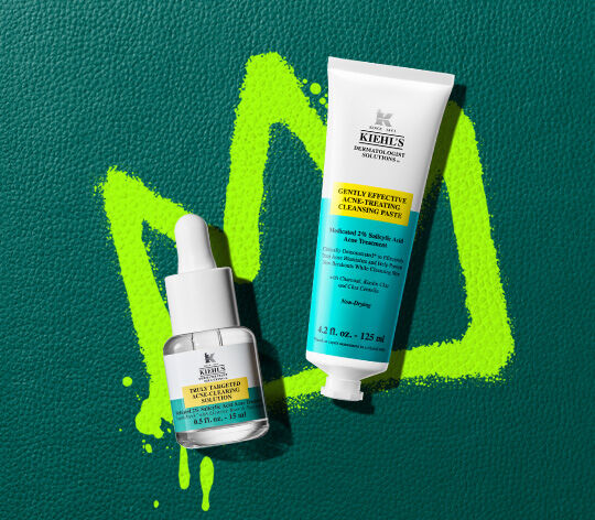 acne spot treatment and acne cleanser on green leather background 