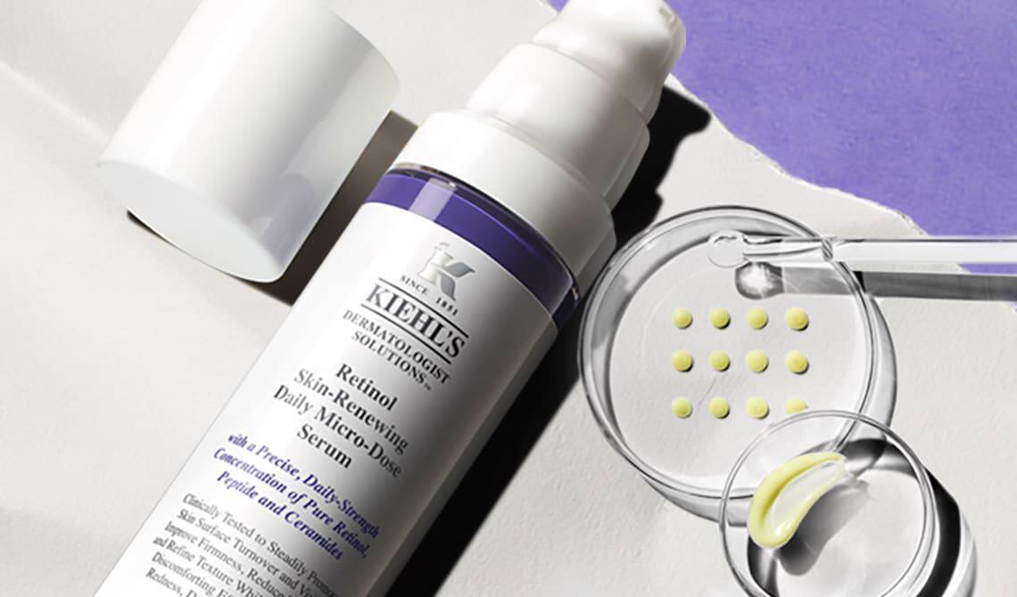 Bottle of Kiehl's Retinol Serum with a Petri dish with formula samples in the background