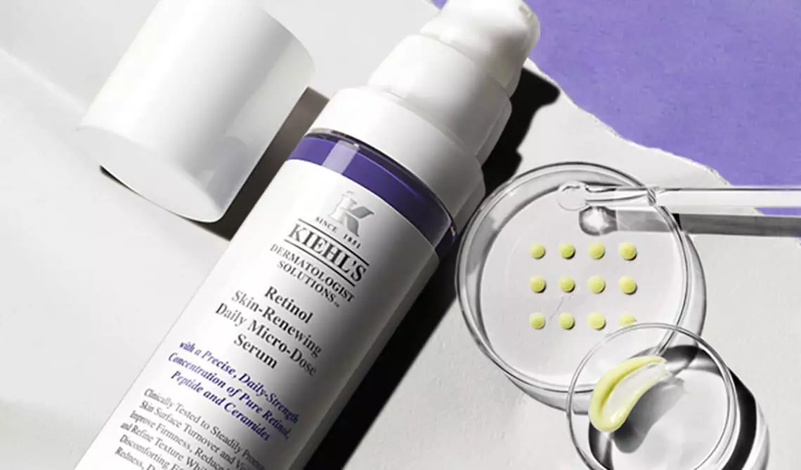 Bottle of Kiehl's Retinol Serum with a Petri dish with formula samples in the background