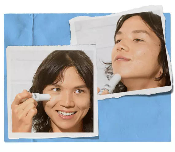 Model applying skincare stick to their cheek and chin