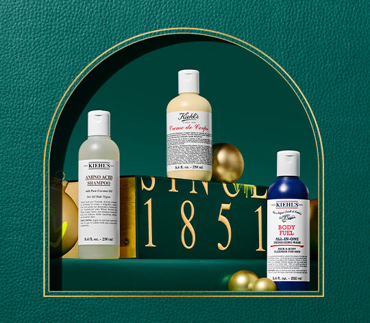 Body care items on green leather background 