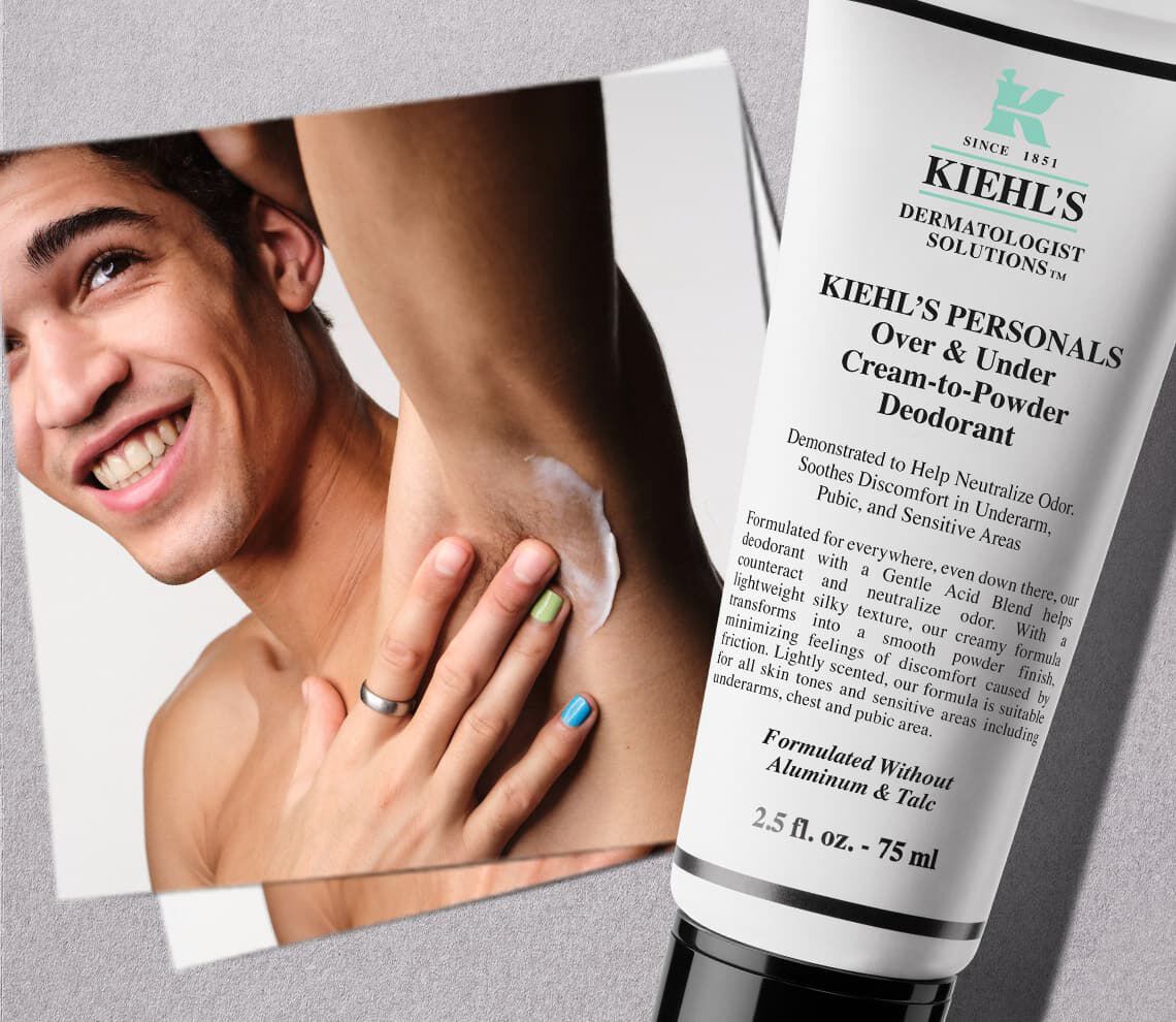Male model adding kiehls over & under cream to powder deodorant to his armpits 