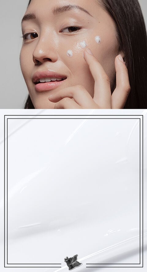 A woman with drops of cream lined on her face