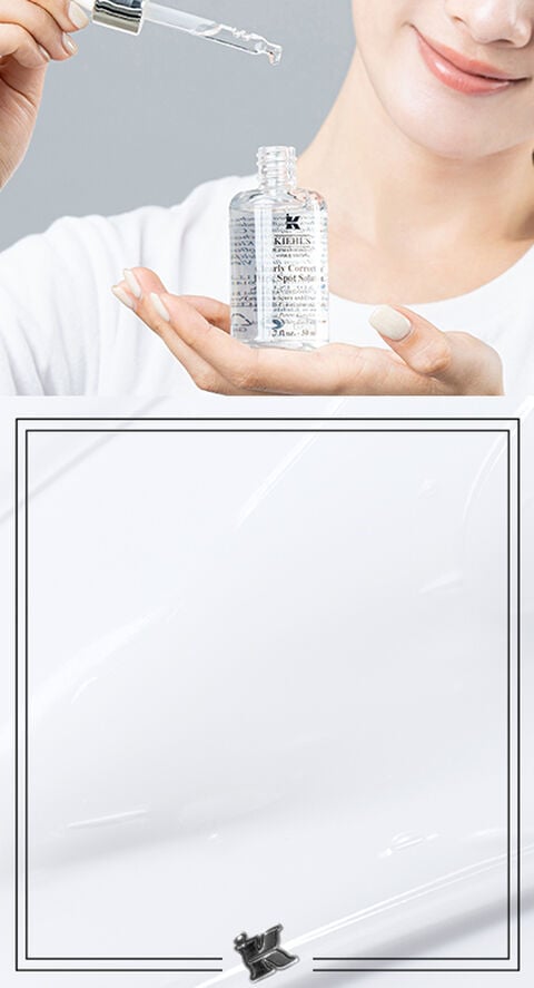 A woman using Kiehl's Clearly Corrective Dark Spot Corrector