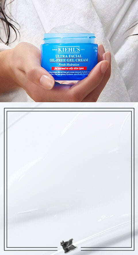 A woman holding Kiehl's Ultra Facial Gel Cream