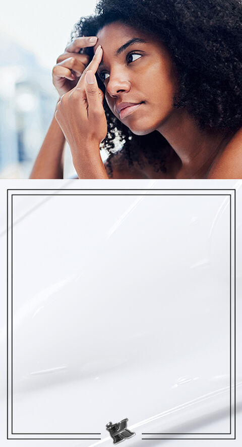 A woman looking at her blemishes
