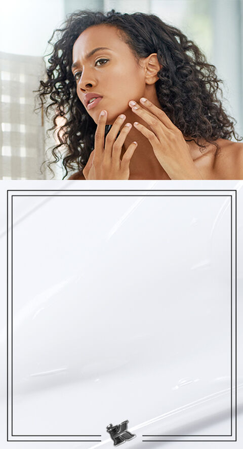 A photo of a woman checking her face for breakouts