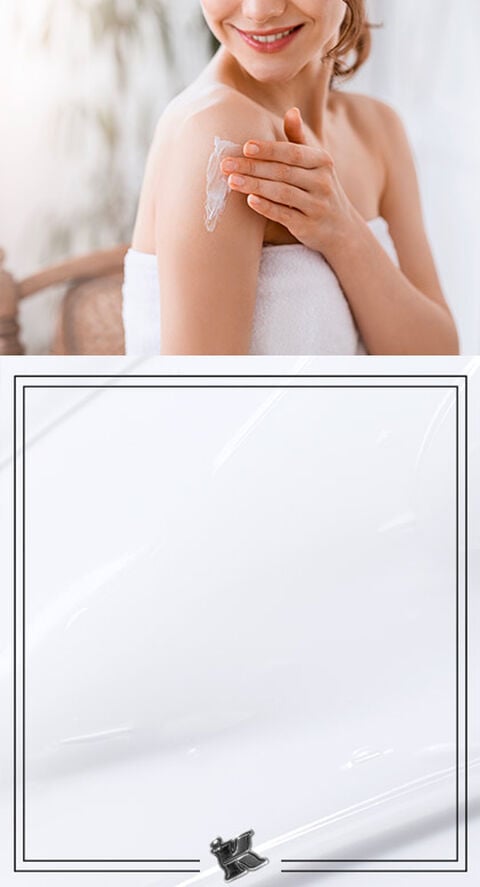 Someone lightly touching their shoulder in a bath towel.