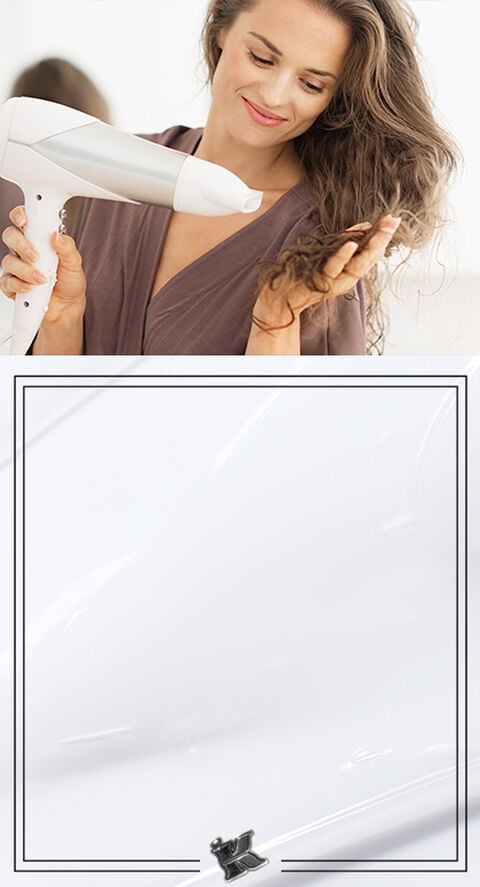 A woman blow drying her hair