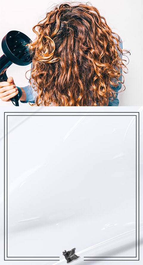 A person with bouncy curls using a hair diffuser