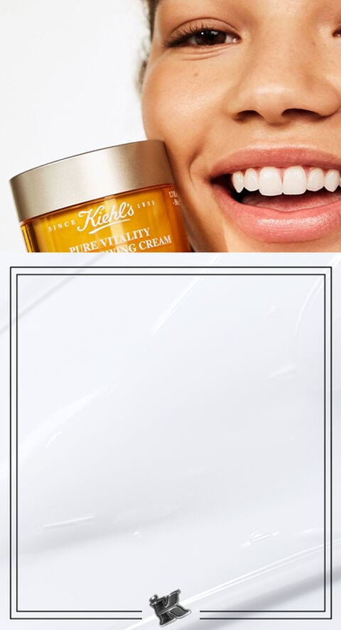 A woman holding Pure Vitality Skin Renewing Cream