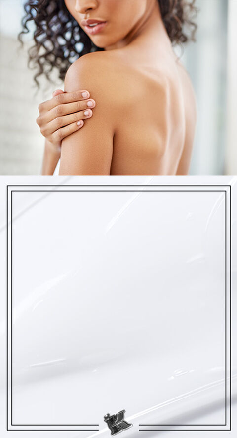 A photo of someone checking their skin out in a bathroom mirror.