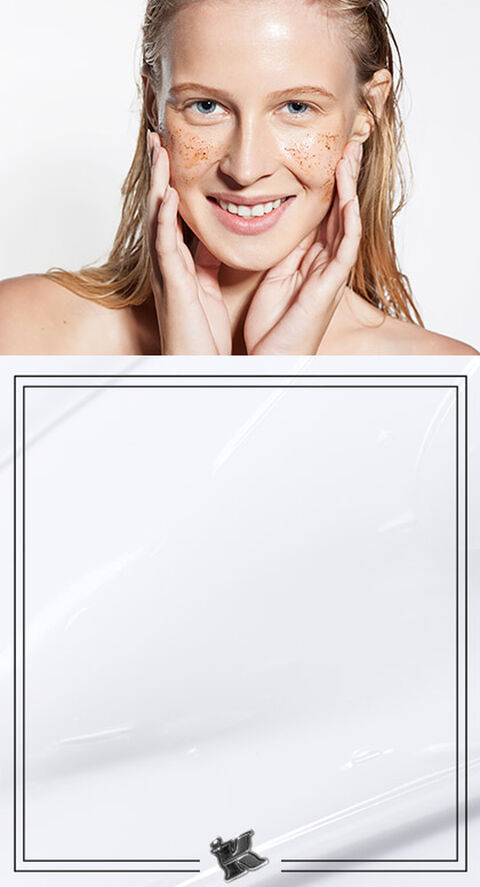 A woman smiling touching her face
