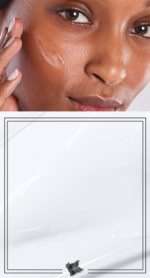 A woman rubbing a lotion on her face