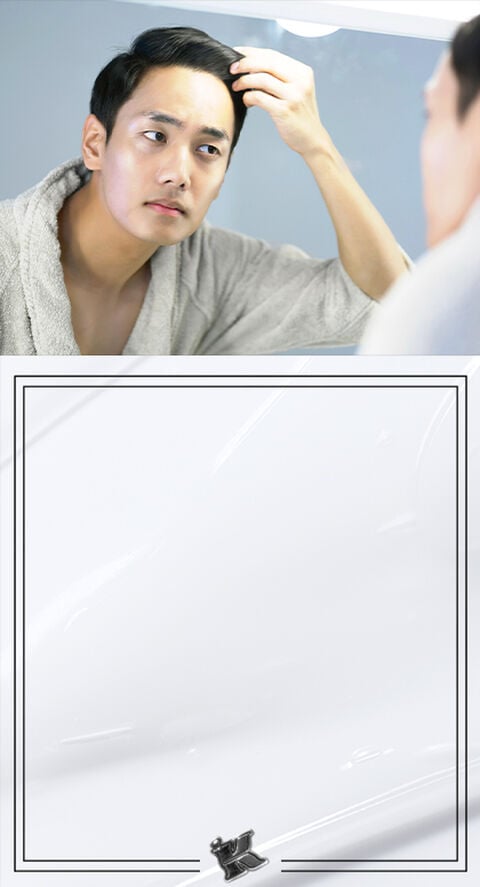 A person looking at the texture of their skin in a bathroom mirror.