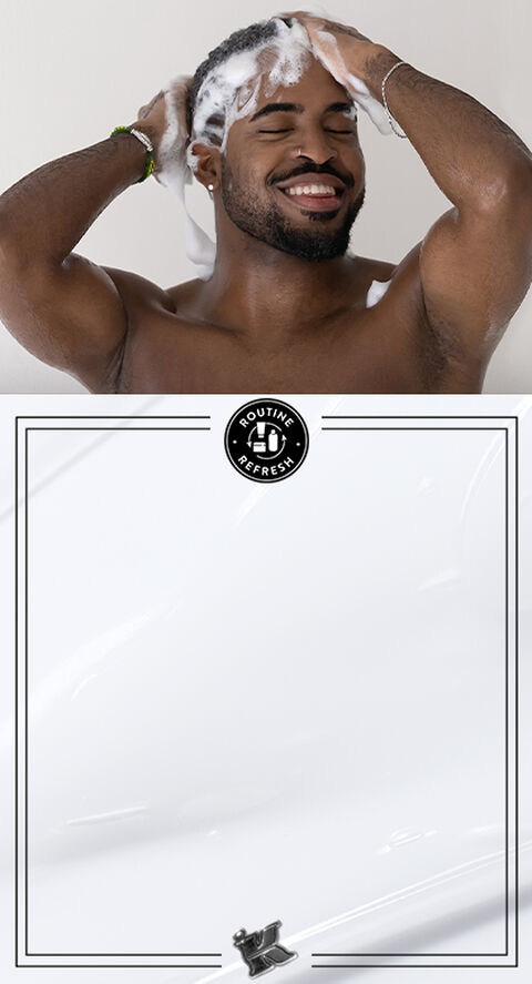 A person lathering their head in a shower.