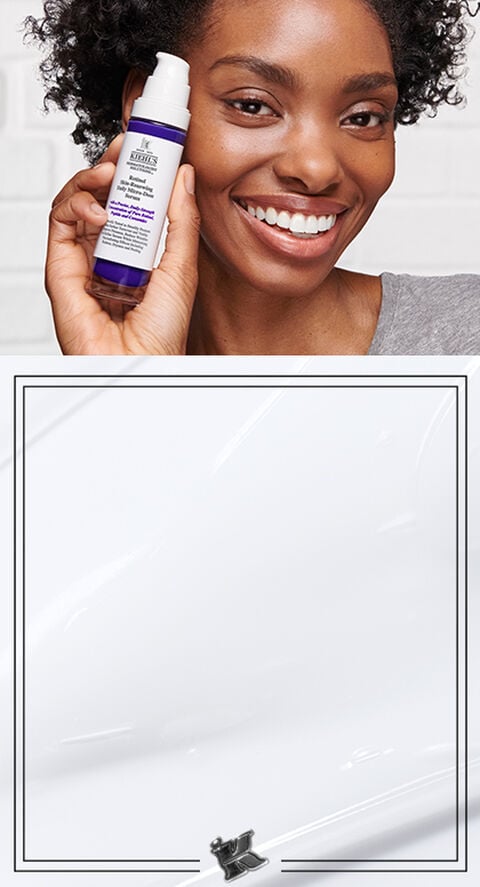A woman holding Micro-Dose Anti-Aging Retinol Serum with Ceramides and Peptide