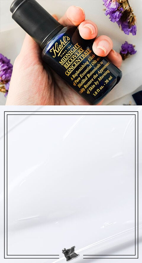 Someone holding Kiehl's Midnight Recovery Concentrate in their hands.