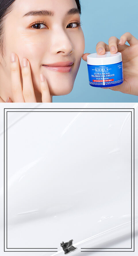 A woman touching her face and holding a jar of Kiehl's Ultra Facial Oil-Free Gel Cream