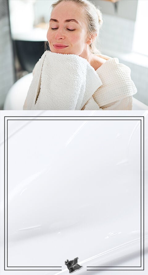 A person lightly rubbing a bath towel on their face.
