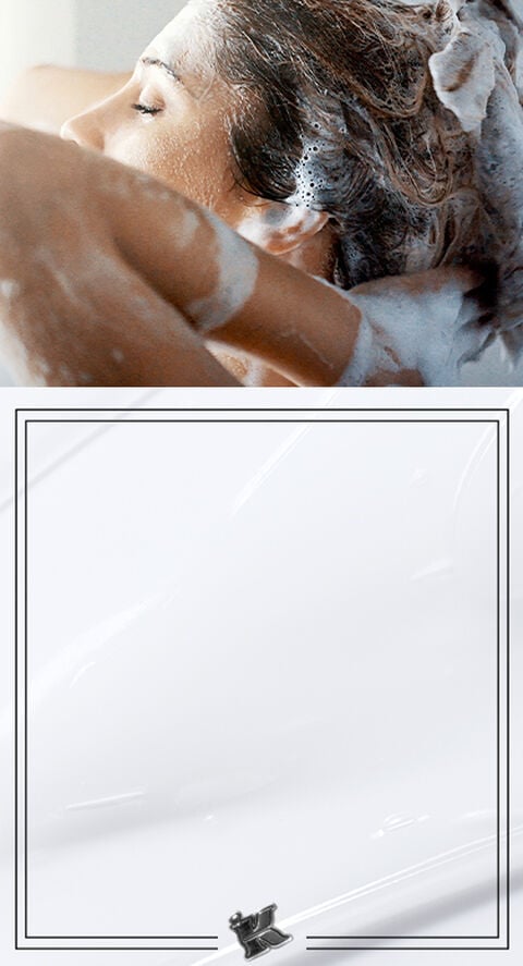 A woman lathering up her hair