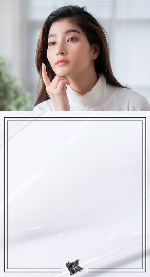 A person looking in a mirror checking to see a blemish on their face